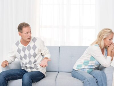 medium-shot-upset-couple-sitting-couch_23-2148334683